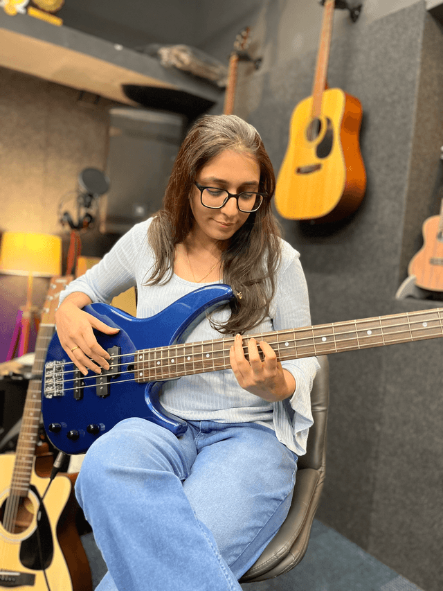 Komal Rangoonwala playing bass guitar